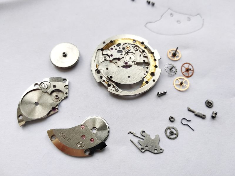 The cleaned movement components arranged for reassembly