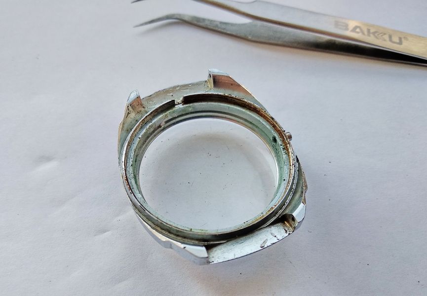 The interior of the empty watch case before cleaning