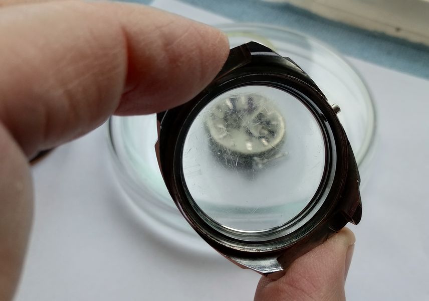 The cleaned empty case held up and viewed through its hazy scratched crystal