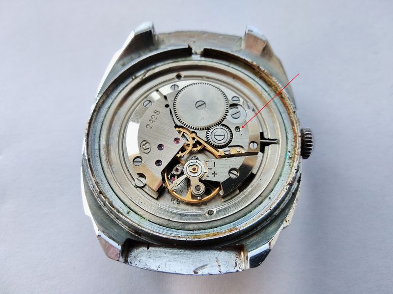 Pressing the stem-release button to withdraw the winding stem from the movement