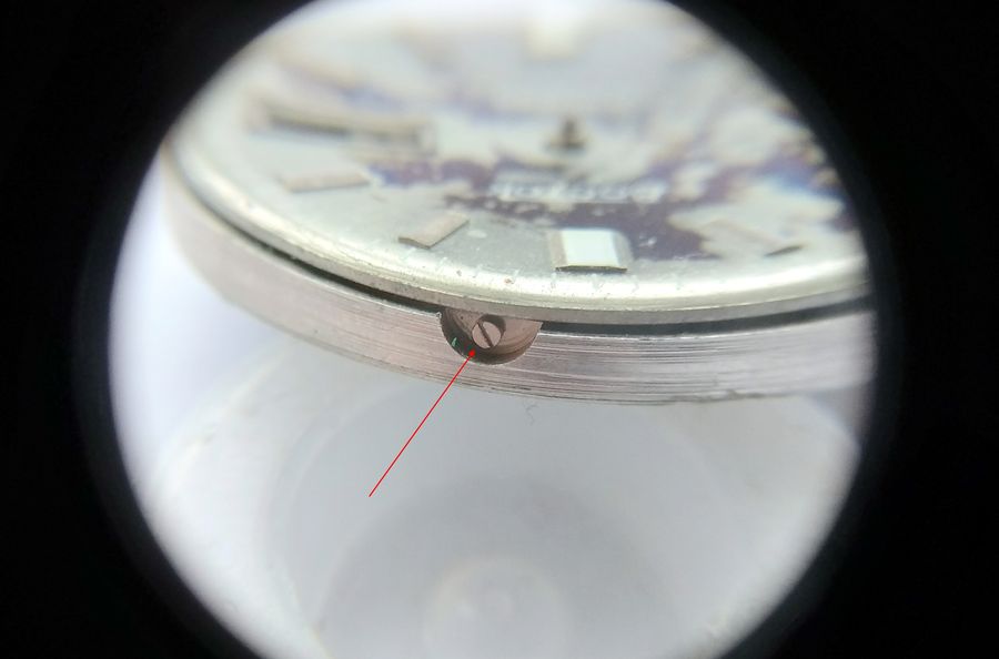 Loosening the large dial-foot screws on the side of the carrying ring