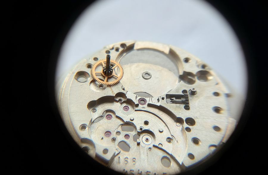 The center wheel being removed from its jewel, completing the fast-side teardown