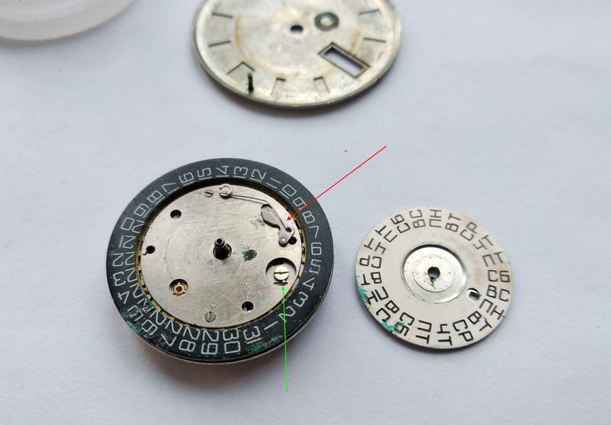 The day-of-week disc removed, exposing its detent lever with spring and the shifting finger