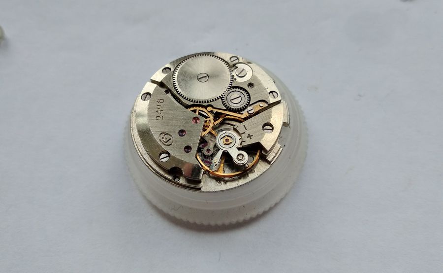 The train side of the 2428 with chamfered bridges and the balance still in place, the caliber number marked on the plate