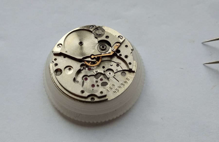The movement with the winding wheels removed, serial number visible