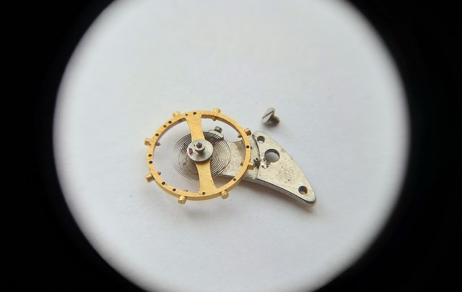 Vostok 2605 balance assembly removed showing screwed balance wheel flat hairspring and balance cock with incabloc seat