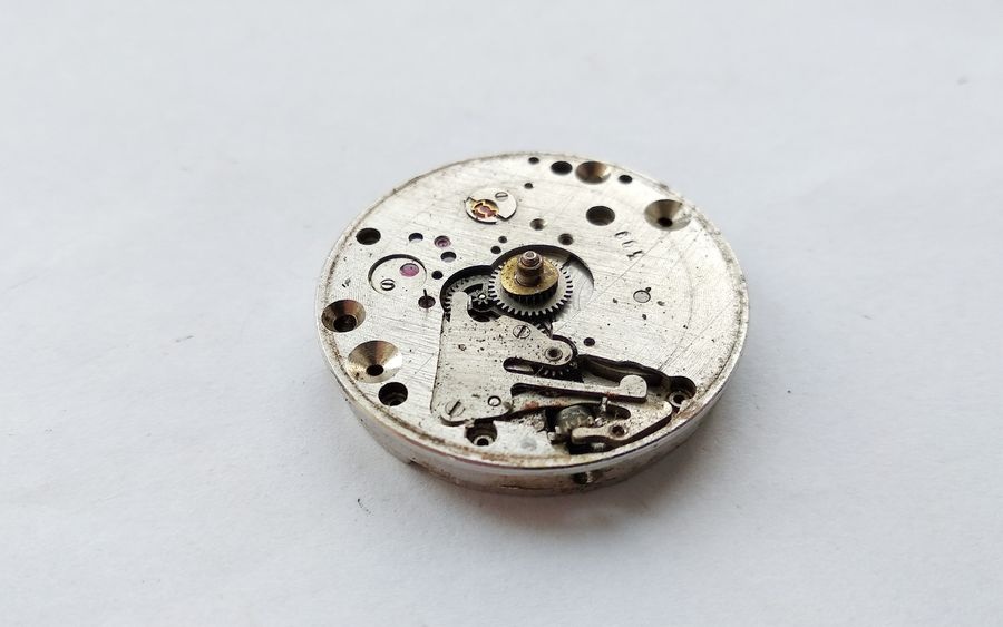 Vostok 2605 movement dial side after dial removal showing motion works hour wheel cannon pinion and keyless works