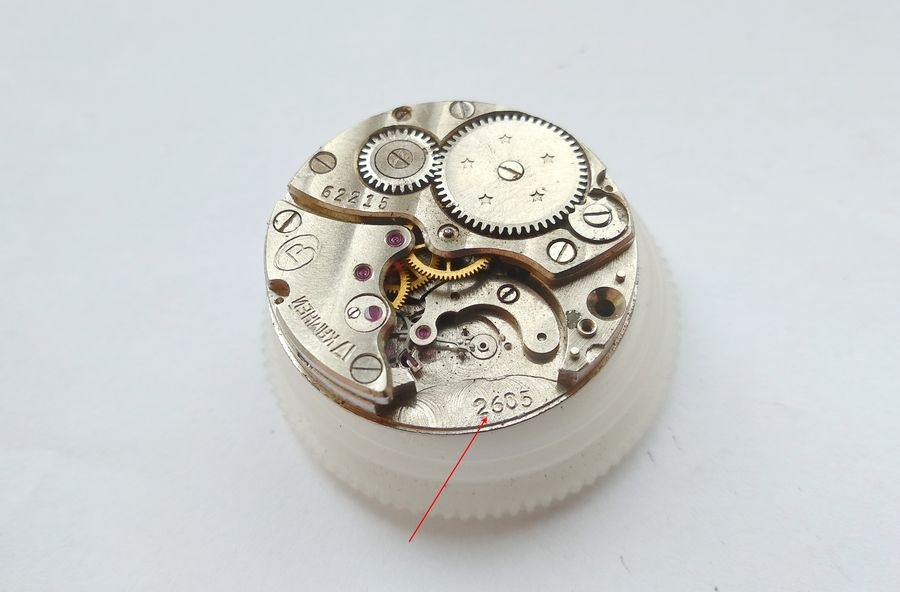 Vostok 2605 movement on holder with caliber 2605 marking visible on main plate beneath balance position