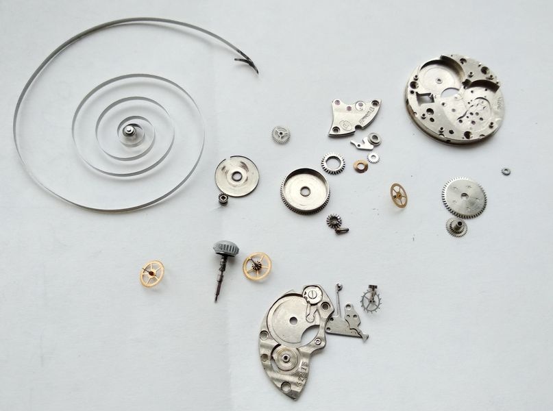 Vostok 2605 all components after cleaning laid out bright and clean showing contrast with pre-cleaning state