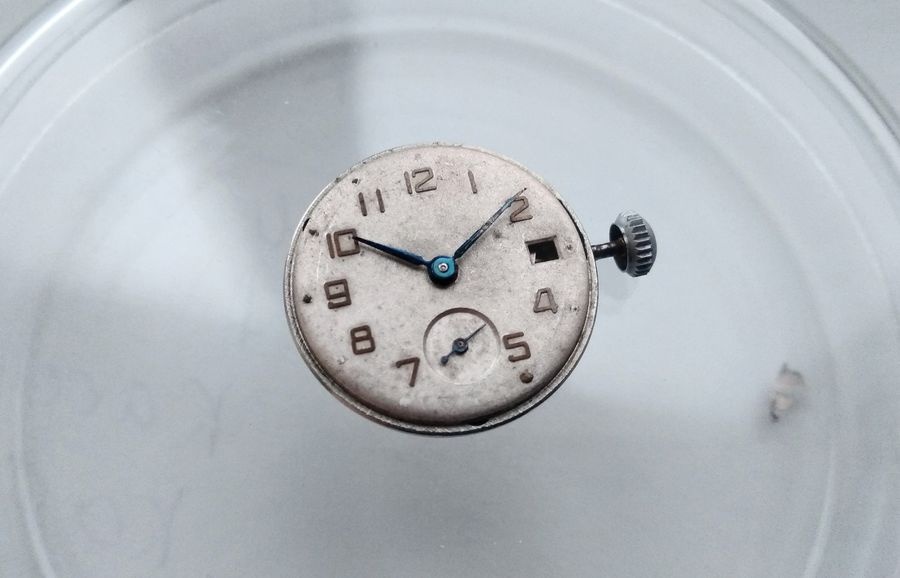 Vostok 2605 movement with dial and hands reinstalled and running showing Arabic numeral dial blue steel hands and empty date aperture