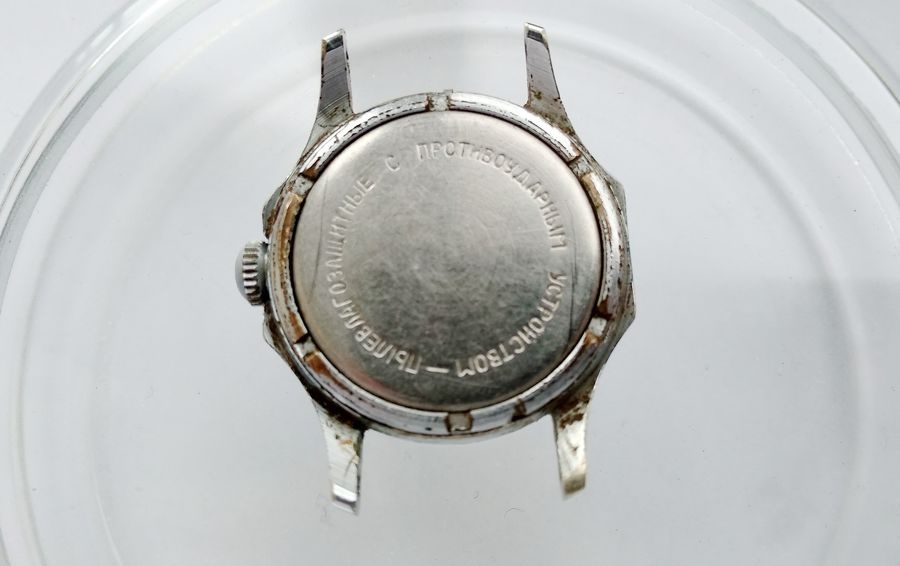 Vostok watch caseback showing Russian inscription confirming dust moisture resistance and anti-shock protection