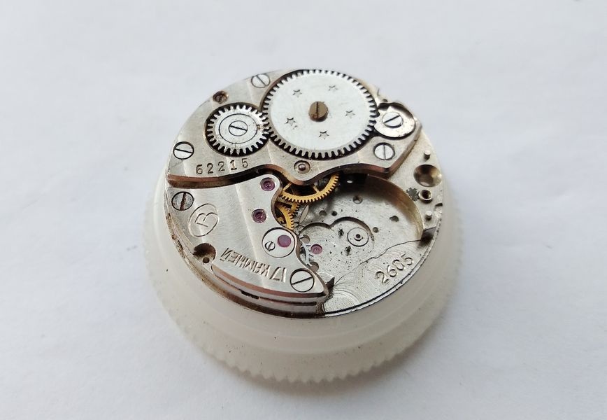 Vostok 2605 movement on holder viewed from gear train bridge side showing bridge with Vostok logo and caliber markings