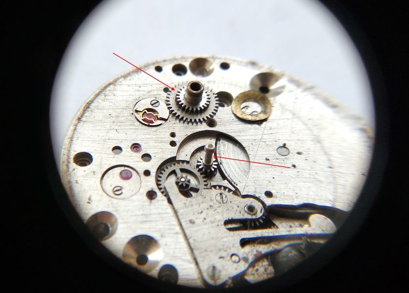 Vostok 2605 dial side through loupe showing two-tier hour wheel and cannon pinion being removed from motion works