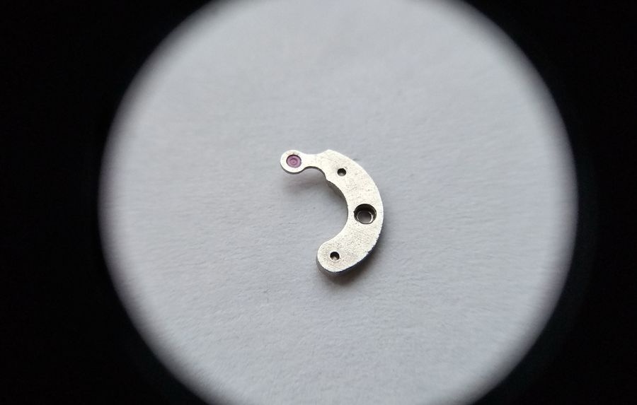 Vostok 2605 pallet fork bridge through loupe inner face showing jewel in arm and pivot hole prepared for installation