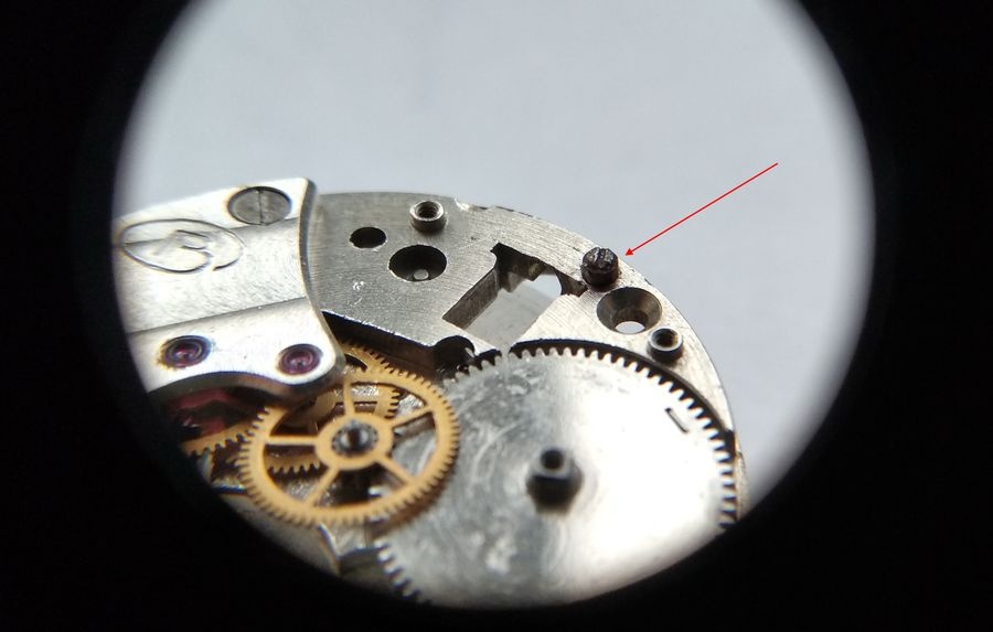 Vostok 2605 movement through loupe showing winding lever screw being returned to its position in winding lever