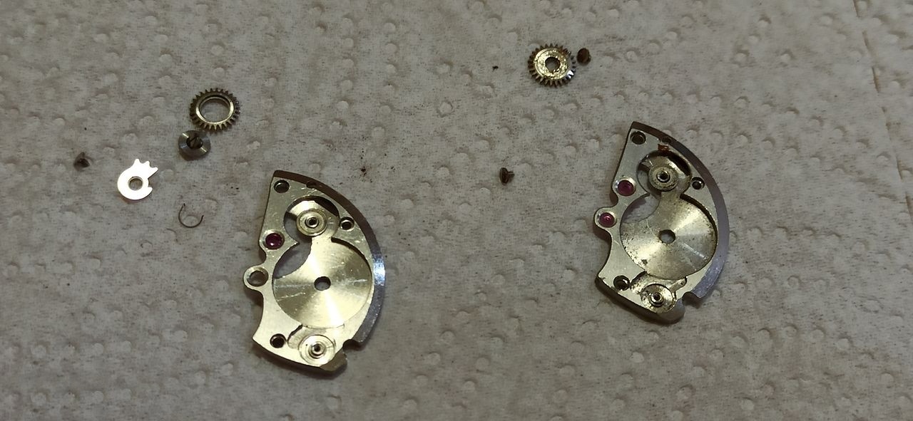 Barrel-bridge components and loose parts laid out before cleaning