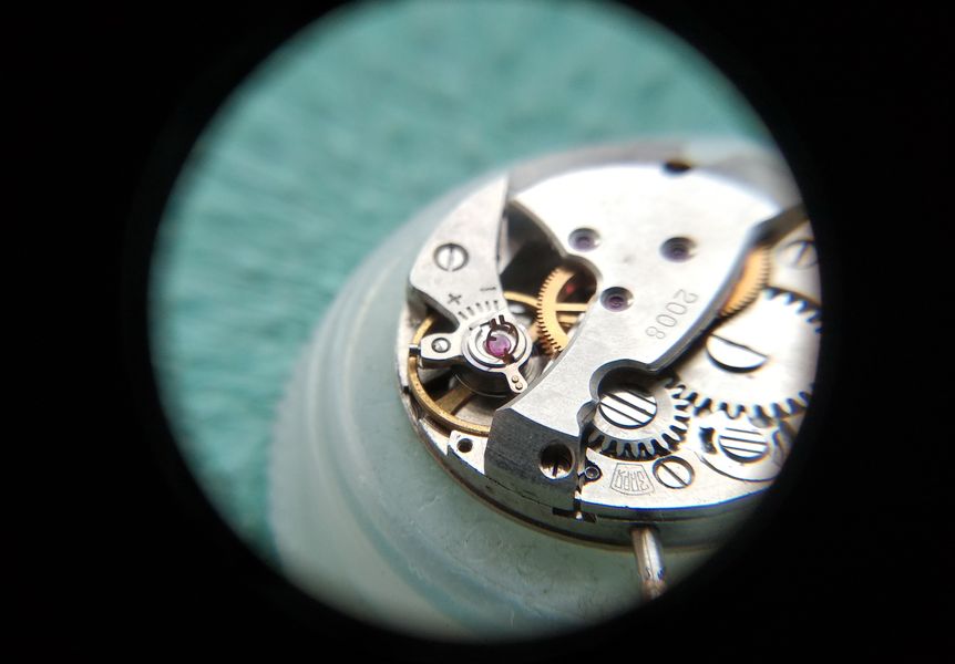 The upper cap jewel being cleaned and lubricated