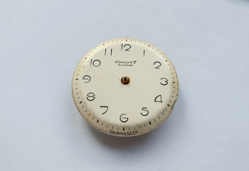 The dial being lifted away from the movement