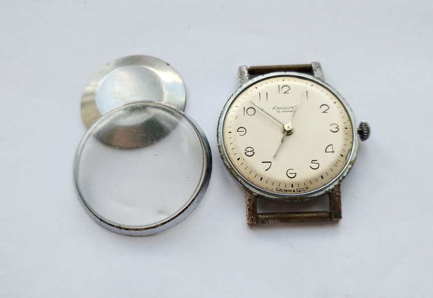 Crystal bezel and scratched acrylic crystal lifted off the watch, exposing the dial