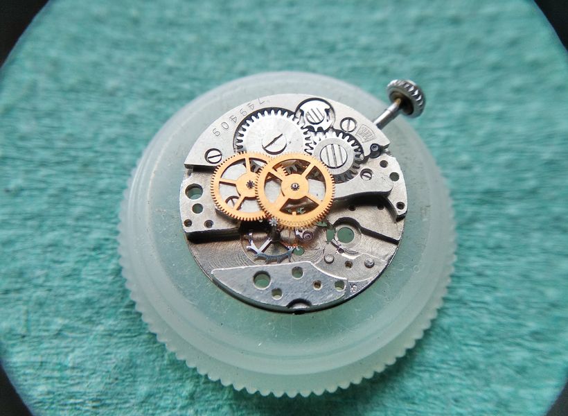 The gear-train bridge installed over the wheels with the jewels being lubricated