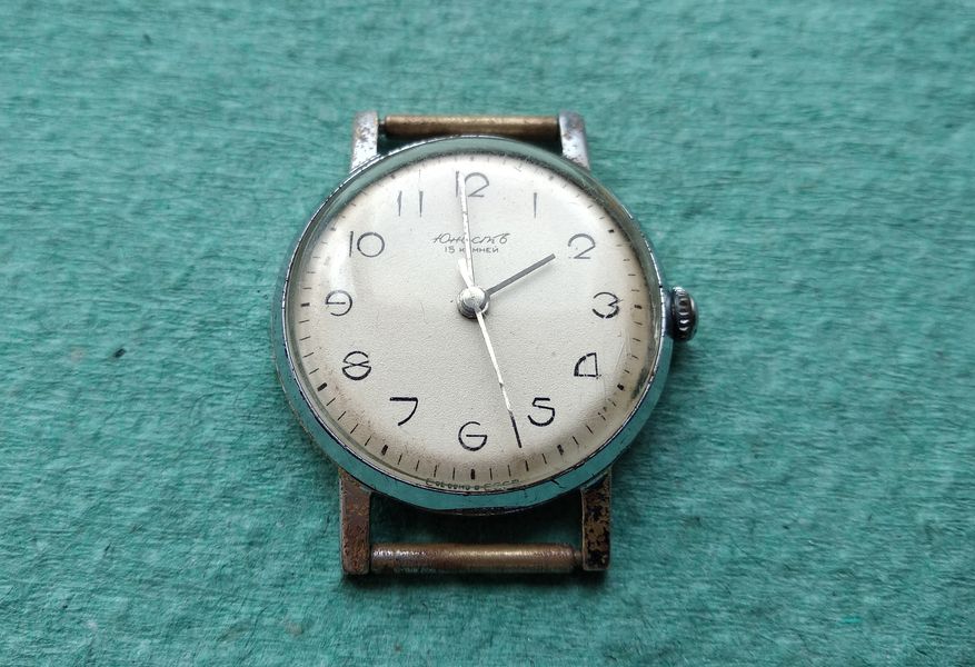 The domed case back being pressed closed over the movement