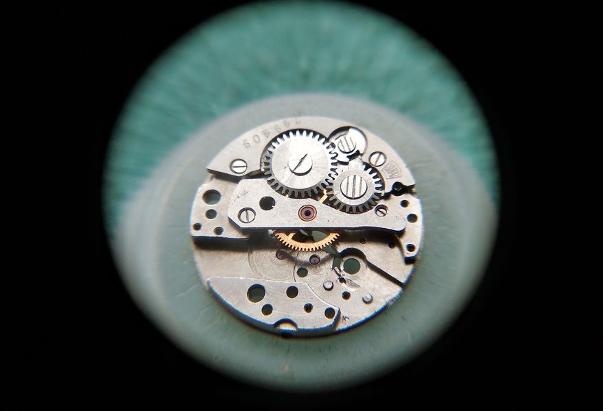 Loupe view of the assembled winding-wheel side of the movement as it is turned over for slow-side assembly