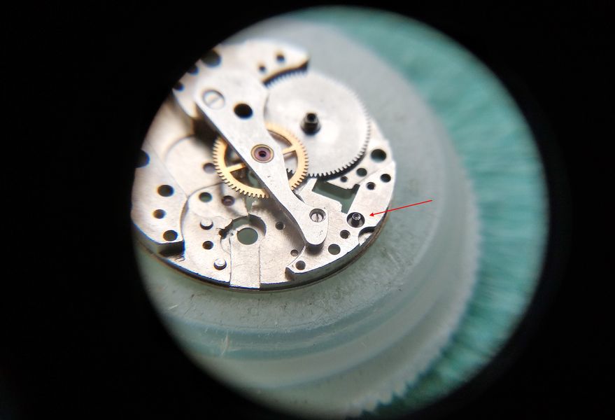 The barrel bridge fitted and the winding wheels installed, with the triple-slotted left-hand crown wheel screw indicated