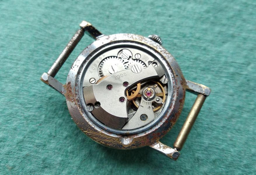 The closed case back of the reassembled watch