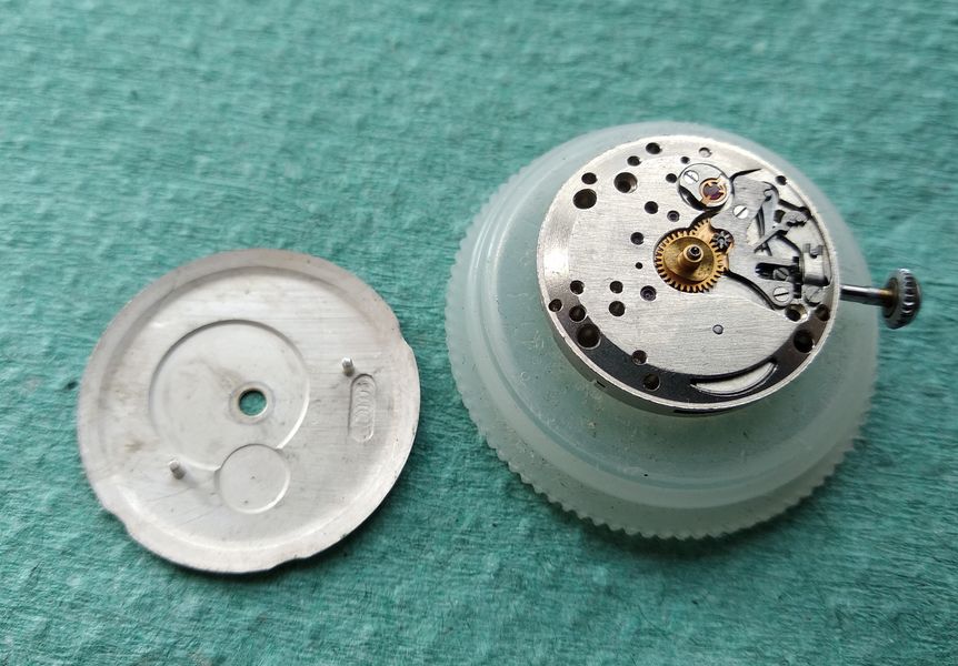 The dial seated on the movement, dial feet secured