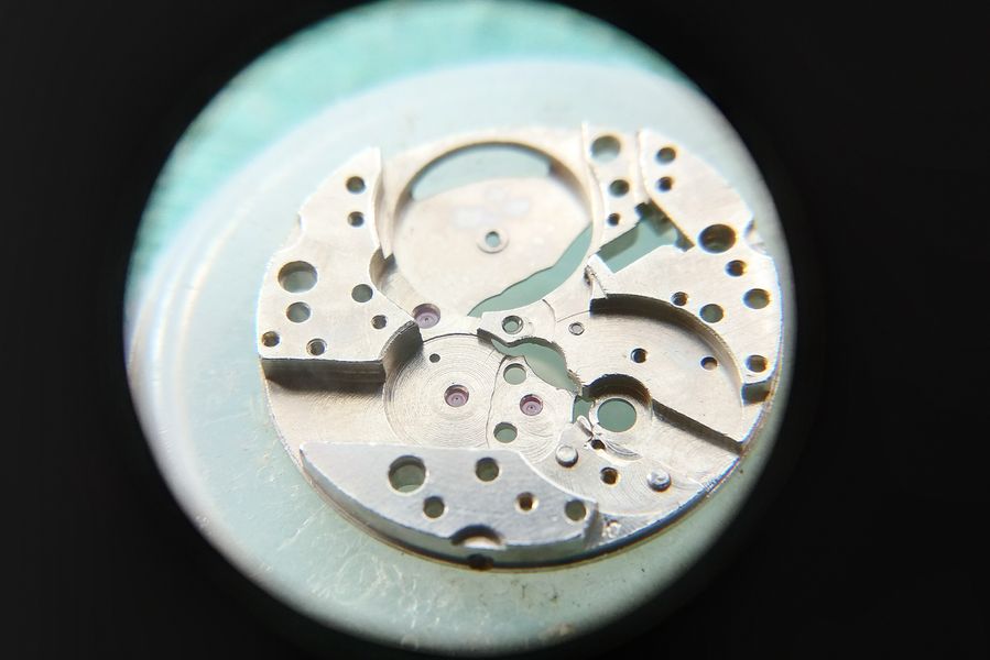 The center wheel held in tweezers before installation