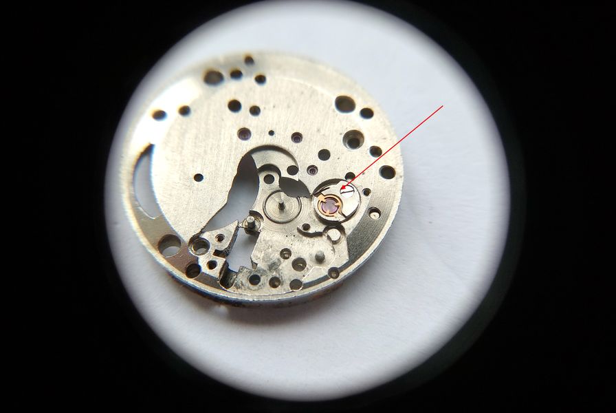 The removable balance bushing being detached from the main plate