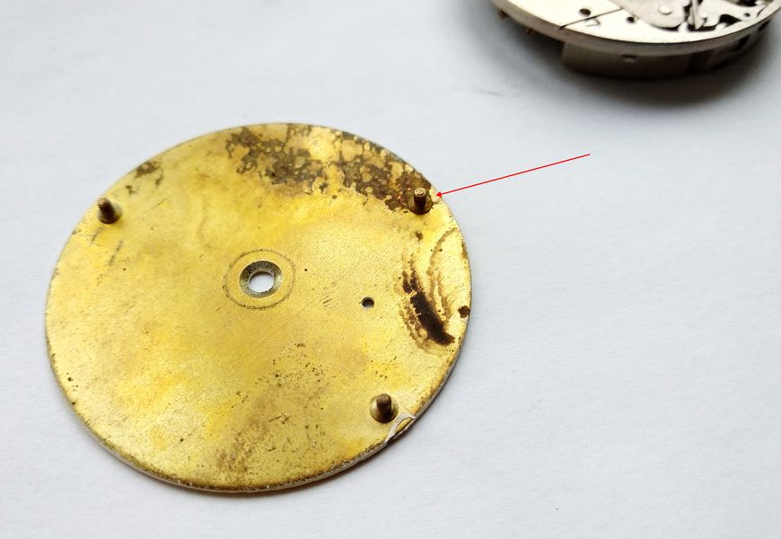 Movement mounted on a bench holder, ready for parts removal