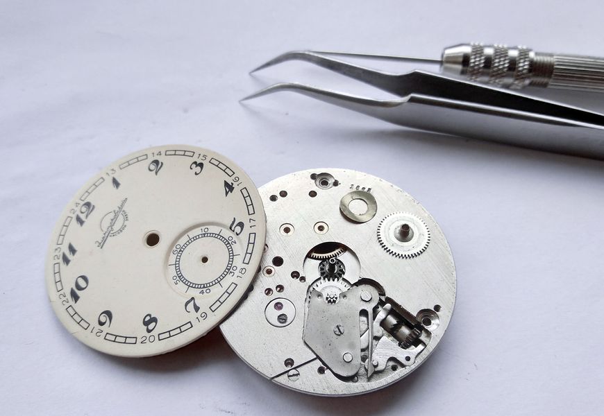 Reverse of the dial showing its three mounting feet
