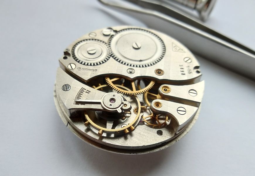 Balance with Breguet overcoil removed, its cock stamped with the matching movement serial
