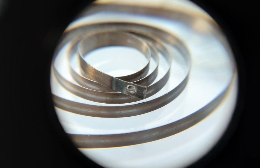 The new hole drilled in the mainspring end, ready for forming into a loop