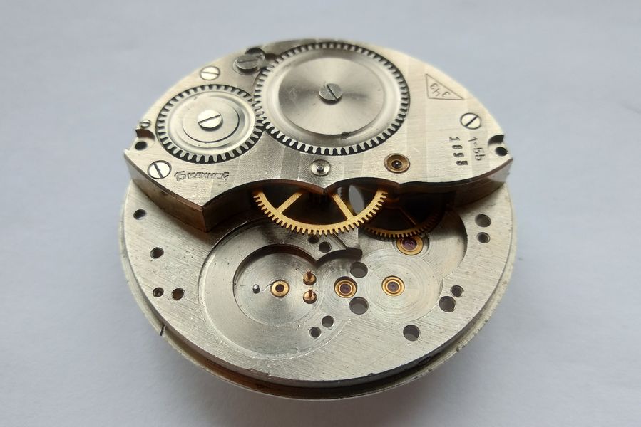 Cannon pinion being removed from the dial side while the center bridge remains