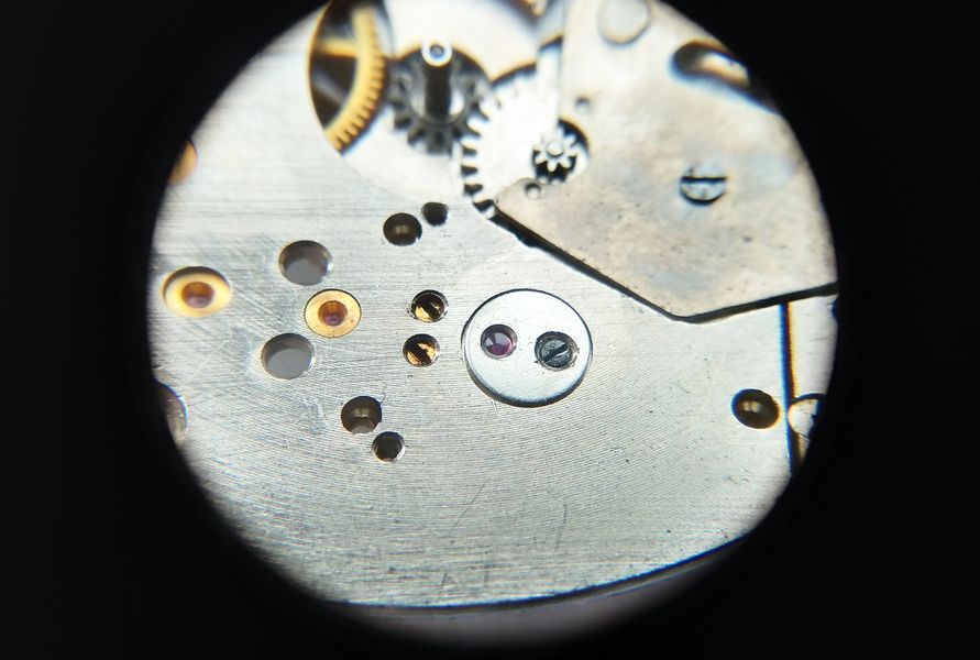 Cap jewel refitted, the oil ring visible through the jewel as an inscribed circle