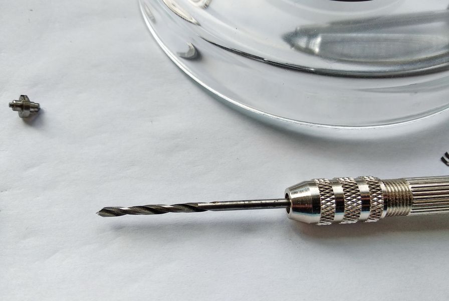 New hole being drilled and shaped in the softened mainspring end with a collet-held drill