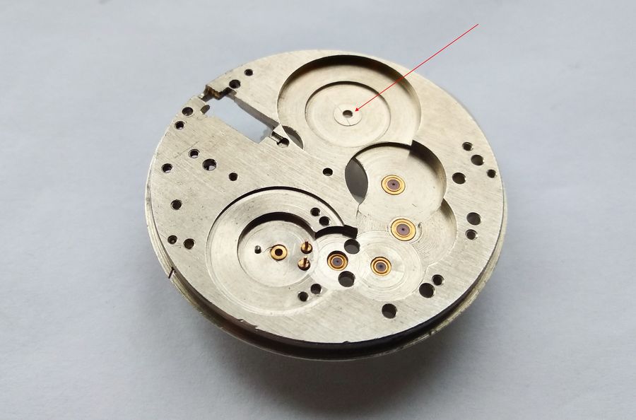Cleaned main plate on the holder, showing the deep barrel-arbor bearing seats