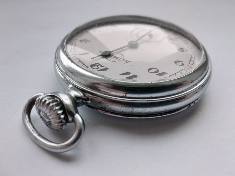 Close-up of the silvered dial showing the Zlatoust factory emblem and black numerals